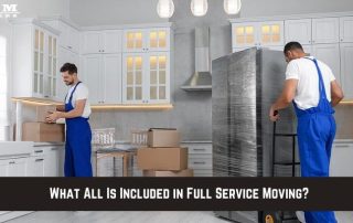 Two movers in blue overalls pack boxes and move a wrapped refrigerator in a modern white kitchen. Text at bottom reads, What All Is Included in Full Service Moving?.